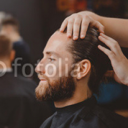 Barber-shop.-Man-in-barbershop-chair-hairdresser-styling-his-hair.jpg