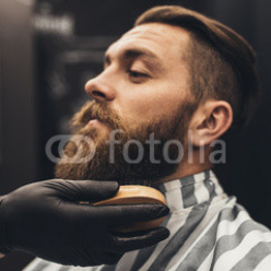 Hipster-young-good-looking-man-visiting-barber-shop.-Trendy-and-stylish-beard-styling-and-cut..jpg